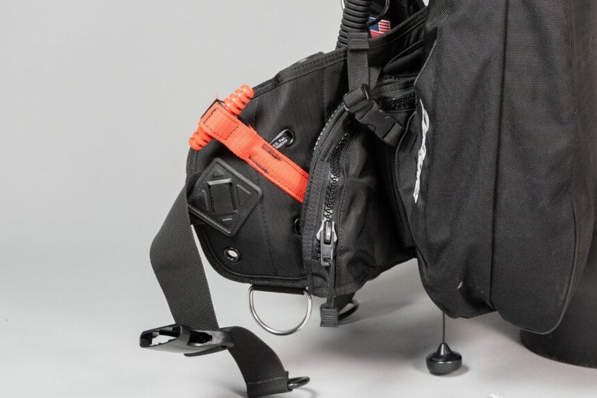 Zeagle BCD Weight Pocket And Ripcord Side view of the Zeagle BCD's weight pocket with its orange Ripcord handle and zipped storage pocket
