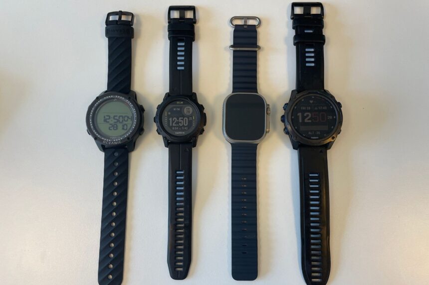 Geo Air Compared With Rival Dive Computers Four wrist dive computers lined up together, from the Oceanic Geo Air to Garmin models and an Apple Watch Ultra