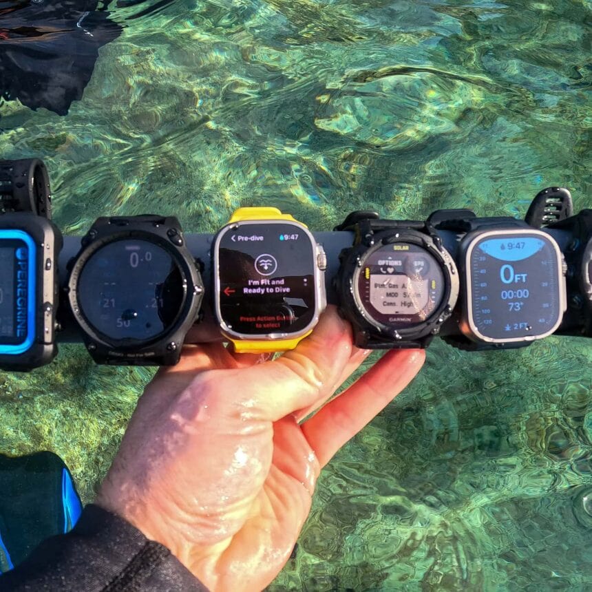 Dive Computer Test Rack Before A Dive Our tester holding a rack of dive computers above clear shallow water before a test dive