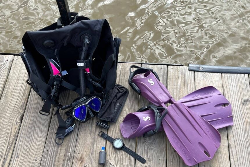 Geo Air Packed With Everyday Dive Gear Oceanic Geo Air and its transmitter packed on a dock beside a BCD, mask and purple fins