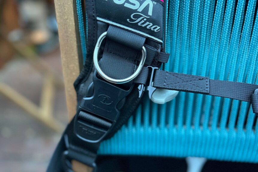 Close-up of a stainless steel D-ring and quick-release buckle on the TUSA Tina's shoulder strap