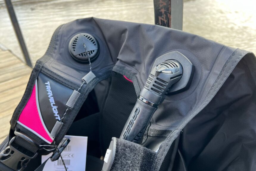 Close-up of the Cressi Travelight BCD shoulder area with its dump valve, inflator and hanging product tag