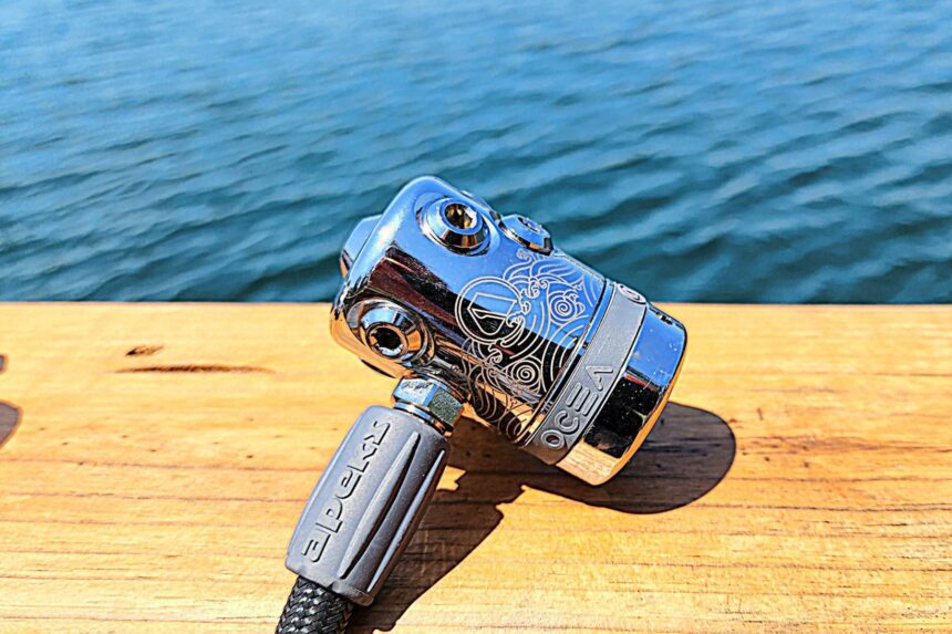 Apeks Ocea First Stage Engraving Apeks Ocea first stage on a wooden dock rail, its engraved chrome body catching the light