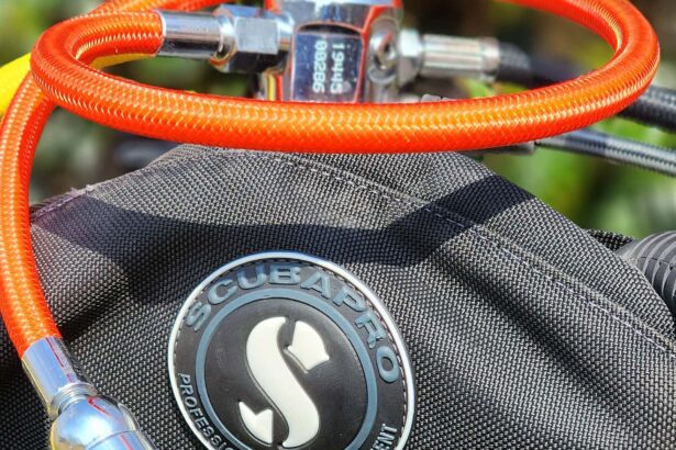 ScubaPro MK17 EVO first stage on a BCD with a bright orange low pressure hose coiled around it