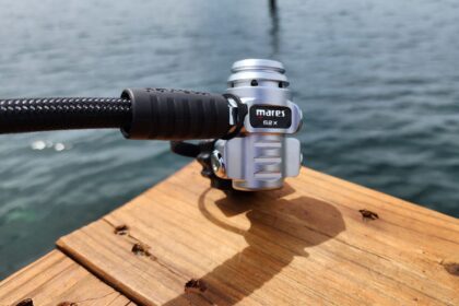 Mares Dual ADJ 62X first stage on a wooden dock board with the sea behind it during DIVEIN testing