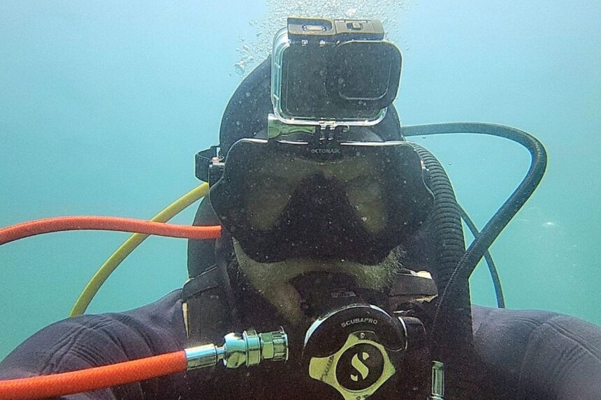 Our tester underwater in a murky quarry wearing the Octomask with a GoPro mounted on top
