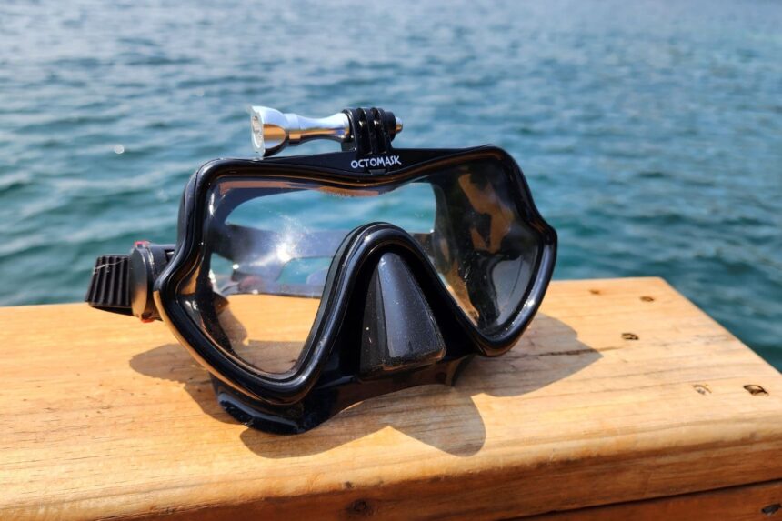 Octomask sitting on a dock rail with its camera mount empty, water behind