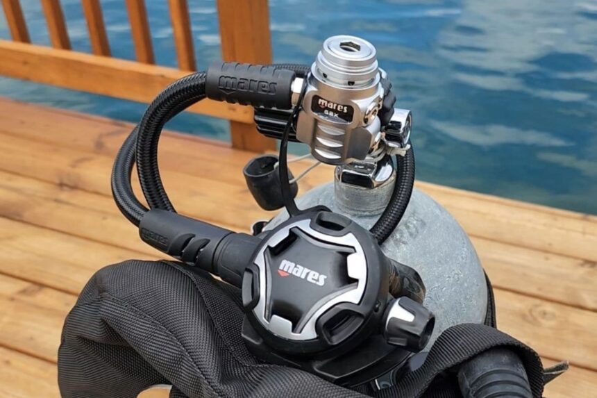 Mares Dual ADJ 62X rigged on a tank and BCD at a poolside deck before a dive
