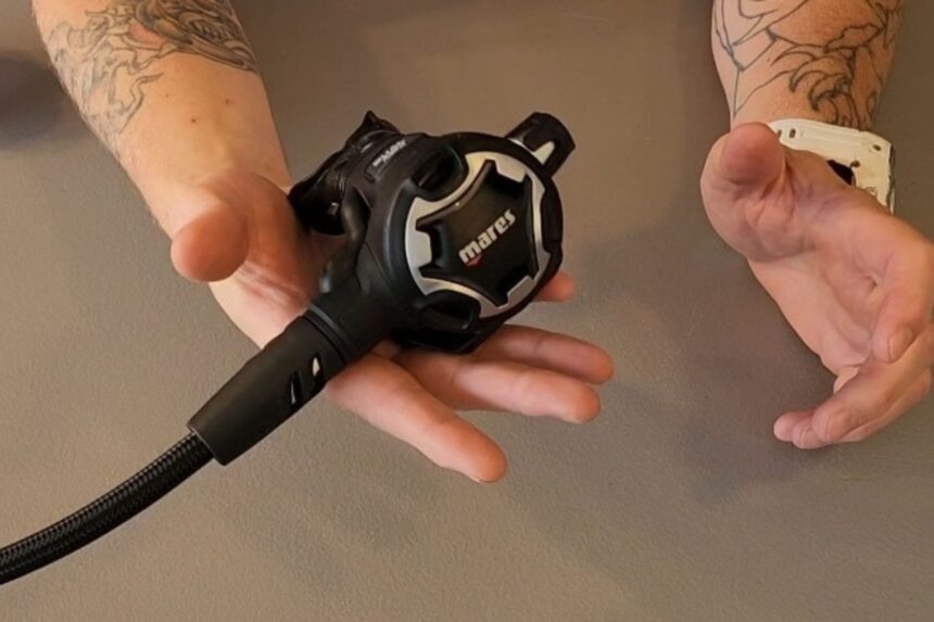 Our tester holding the lightweight Mares 62X second stage in the palm of a hand