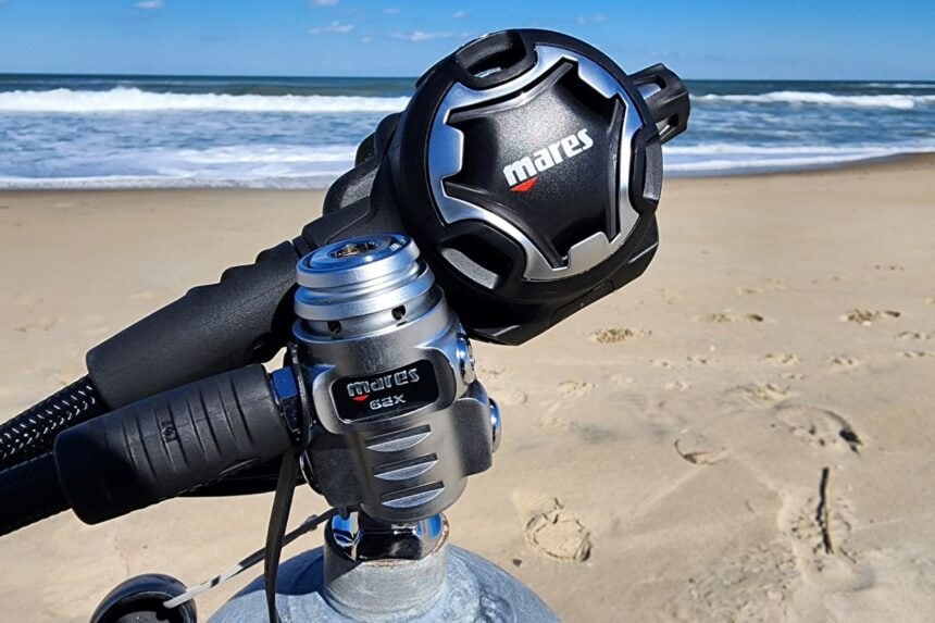 Mares Dual ADJ 62X first and second stage mounted on a tank on a sandy beach