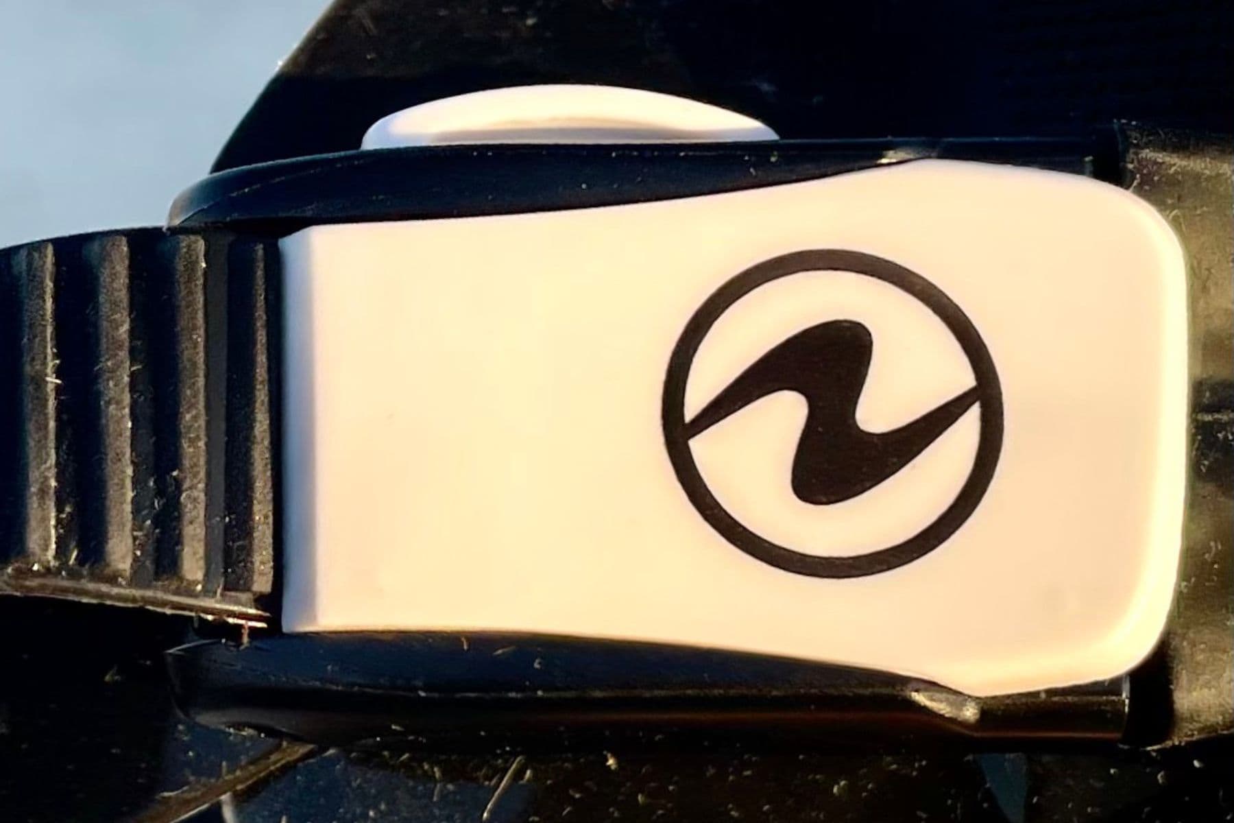White Aqualung buckle on the Reveal X1 mask strap, shown close up