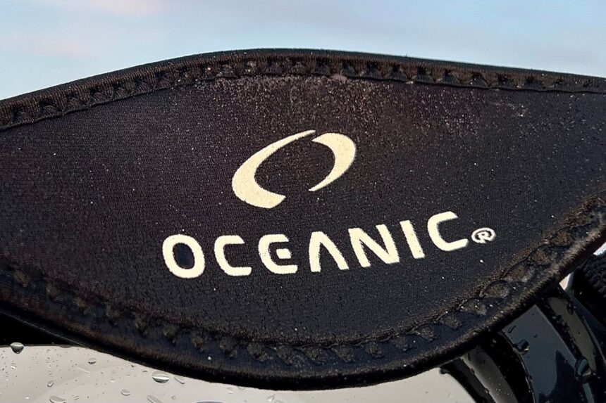 Close-up of the Oceanic logo on the wet neoprene strap of the Shadow dive mask