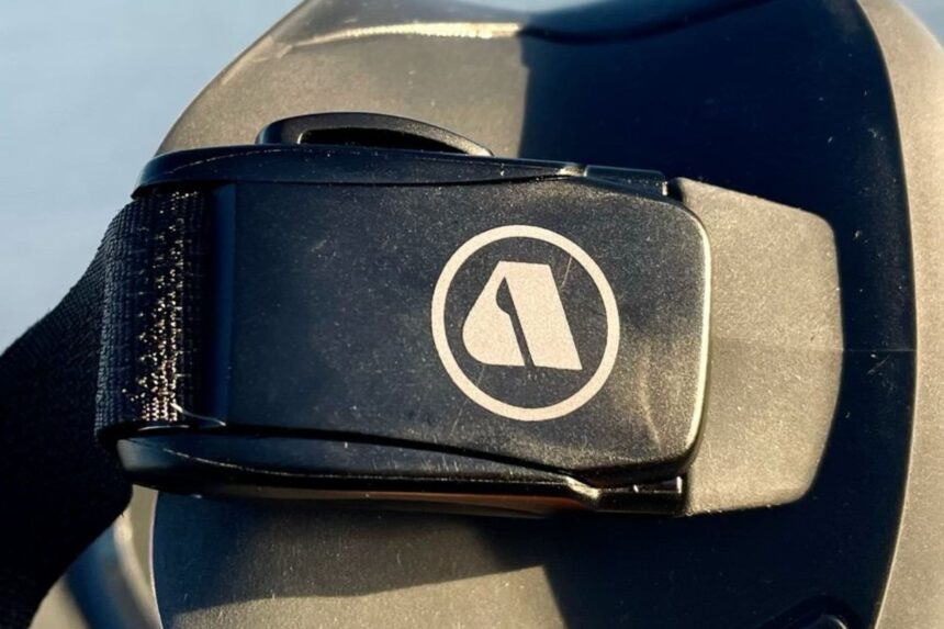 Close-up of the quick-release buckle and Apeks logo on the VX1 mask