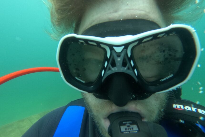 Our tester diving in the Mares Spyder, facing the camera underwater with a regulator in his mouth