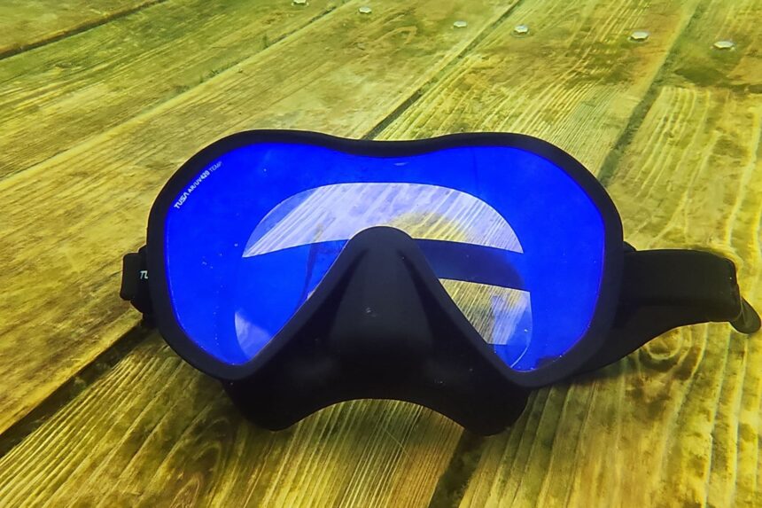 TUSA Zensee Pro lying on a wooden platform underwater with its blue lens facing up