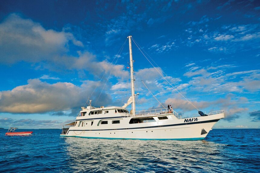 Nai'a liveaboard yacht anchored off Fiji at sunset with a tender boat alongside