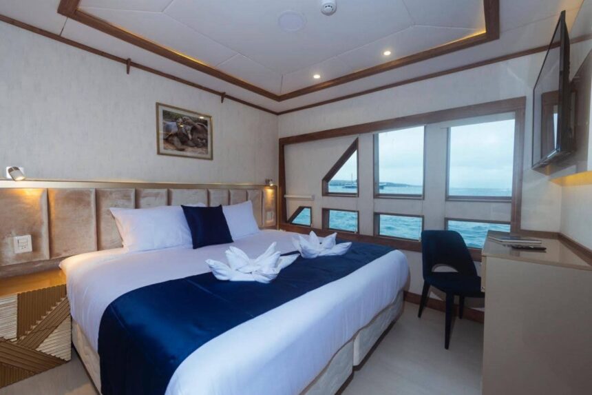 Twin beds with folded towel swans in a Tiburon Explorer cabin