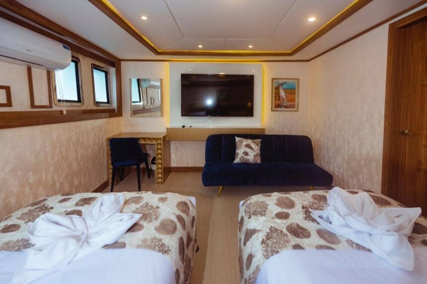 A lounge area with white sofas and a drinks station on the Tiburon Explorer