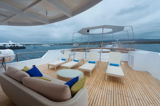 Round tables set for dining on the Tiburon Explorer's open deck at dusk