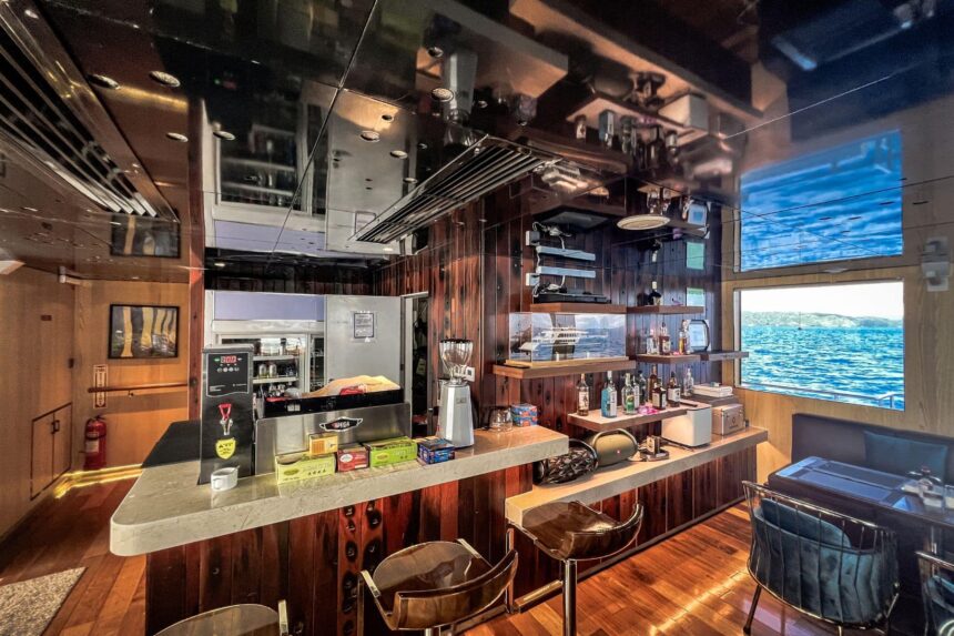 Wood paneled bar with stools aboard the Black Pearl Explorer liveaboard
