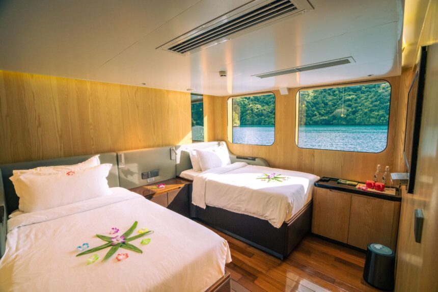 Twin cabin aboard the Black Pearl Explorer with flower petal decorations on the beds