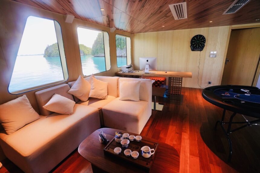 Cabin lounge area aboard the Black Pearl Explorer with sofas, dartboard and desk