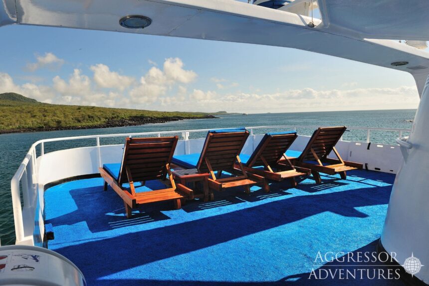 Sun deck lounge chairs overlooking the coastline aboard the Galapagos Aggressor III
