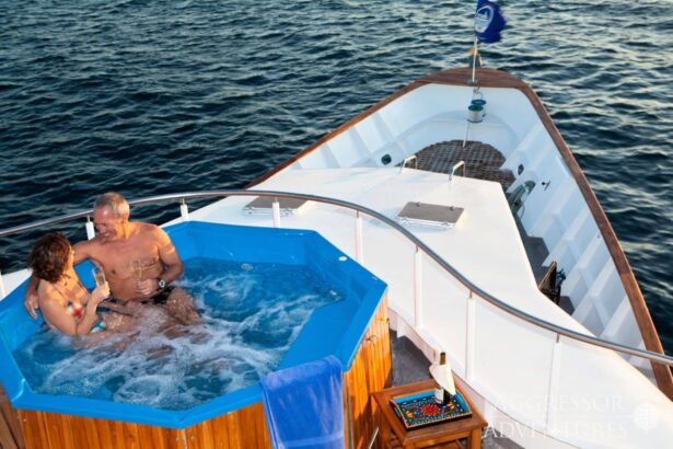 A couple relaxes in the hot tub with champagne aboard the Galapagos Aggressor III