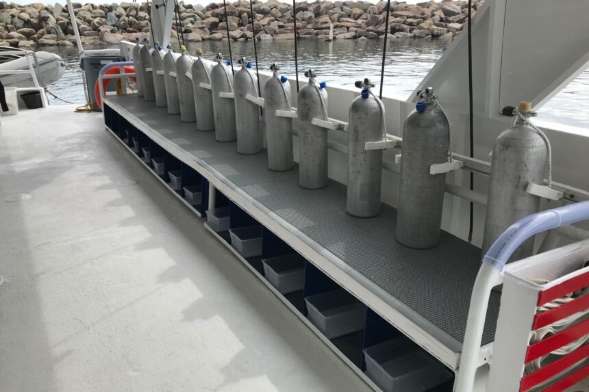 Rows of scuba tanks lined up on the dive deck