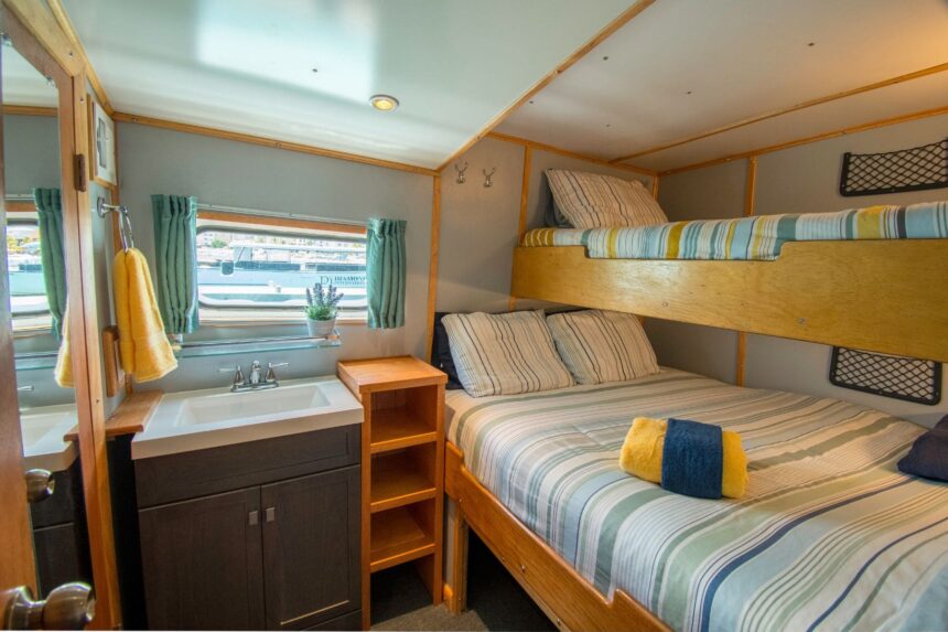 Cozy bunk cabin with striped bedding aboard the Caribbean Explorer II