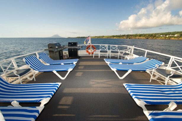 Rows of empty lounge chairs on the sun deck with St. Kitts in the distance