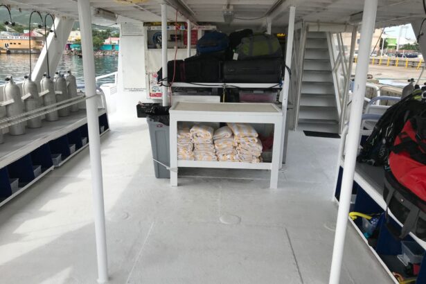 Dive deck stacked with luggage and folded towels before boarding