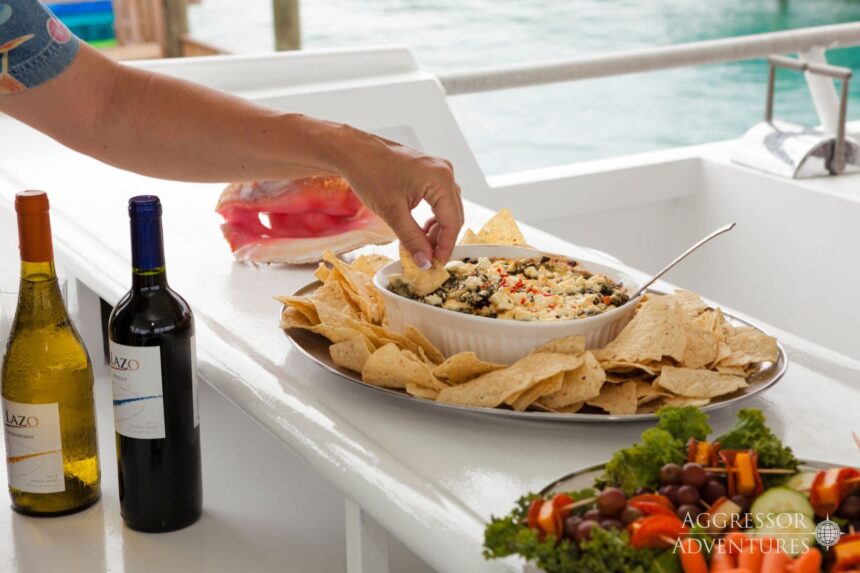Guest dips a chip into spinach dip laid out on the sundeck bar