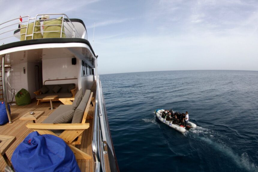 Aerial view of the Emperor Elite's deck with a dive skiff pulling alongside