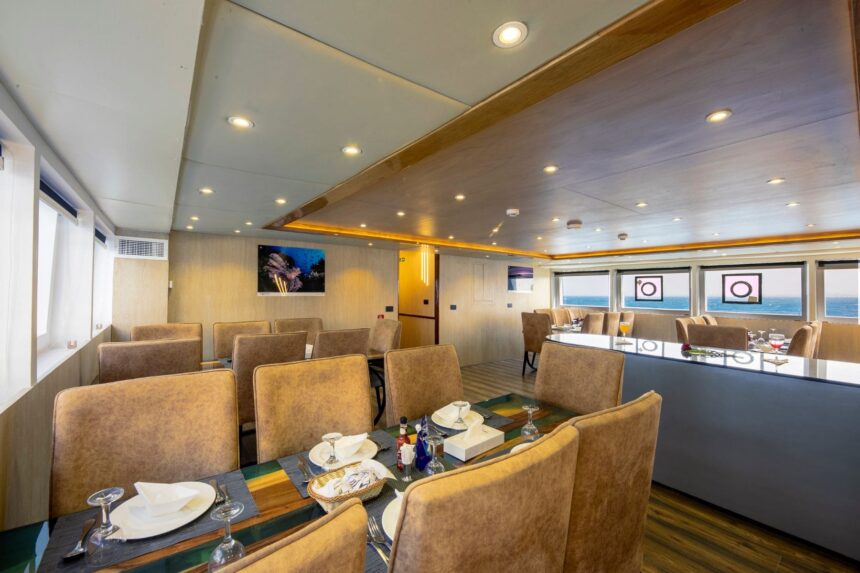 Dining room aboard the Emperor Elite with wraparound windows over the sea