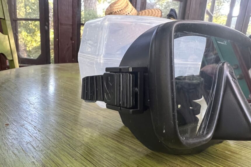 Gorilla Frameless Buckle and Strap Side view of the Gorilla Frameless mask on a table with the strap buckle mounted on the skirt