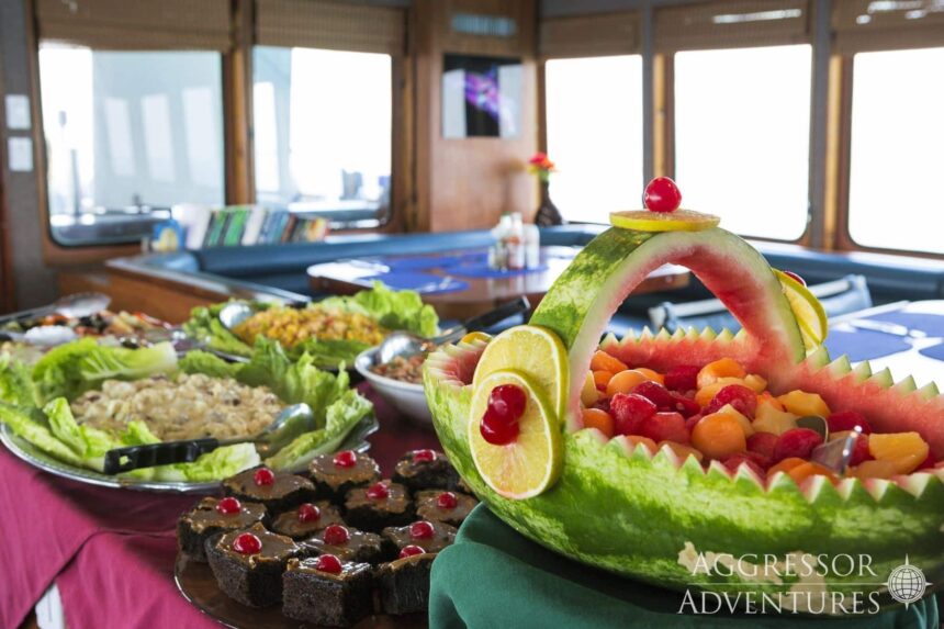 Buffet spread with a carved watermelon fruit boat aboard the Belize Aggressor IV