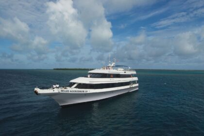 Belize Aggressor IV liveaboard yacht anchored beside a barrier reef