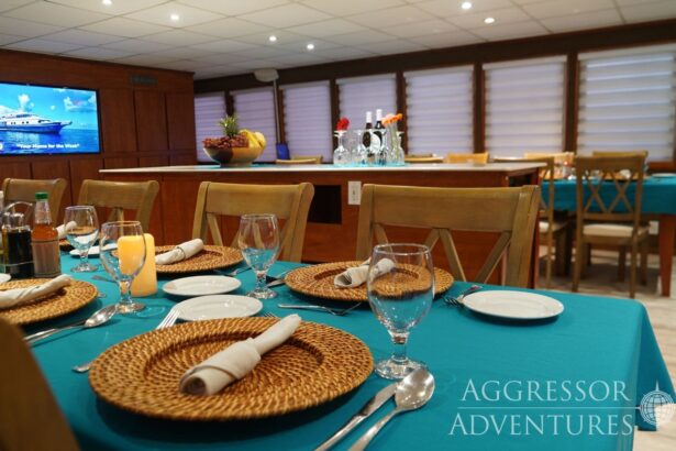 Formal dinner table set with charger plates aboard the Belize Aggressor IV