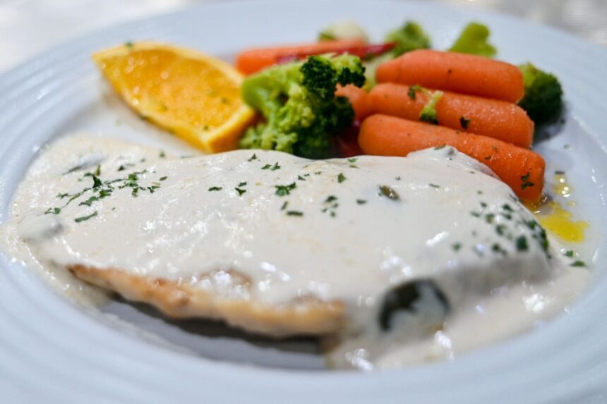 Fish Dinner With Vegetables white fish fillet in cream sauce with carrots and broccoli on the Belize Aggressor III
