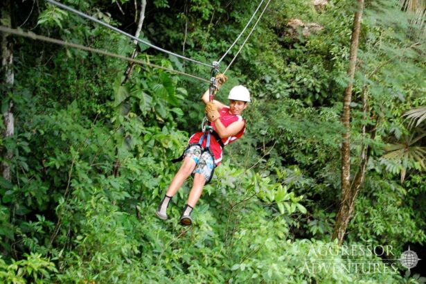 guest ziplining through jungle canopy on a Belize Aggressor III shore excursion
