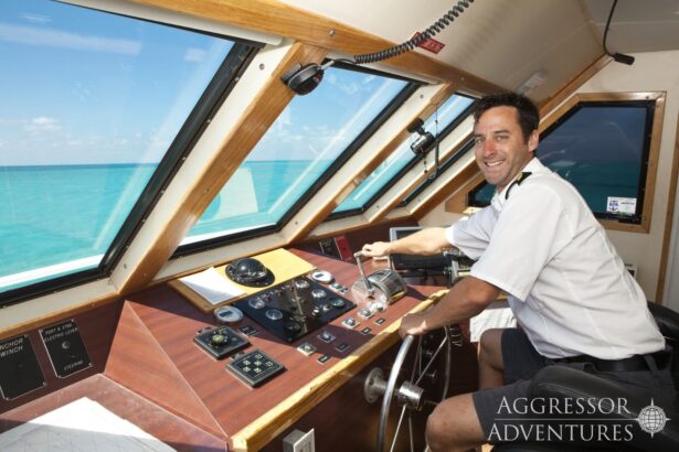 captain steering the Belize Aggressor III from the wheelhouse