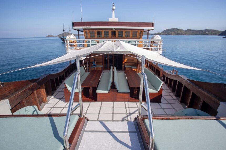 shaded outdoor dining area on the stern deck of a liveaboard at anchor
