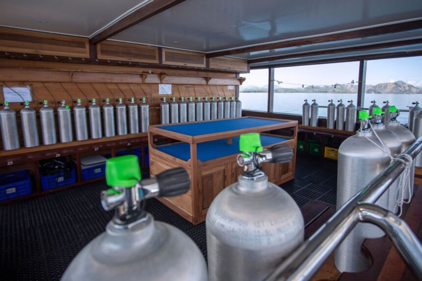 rows of scuba tanks lined up in a liveaboard's dive deck