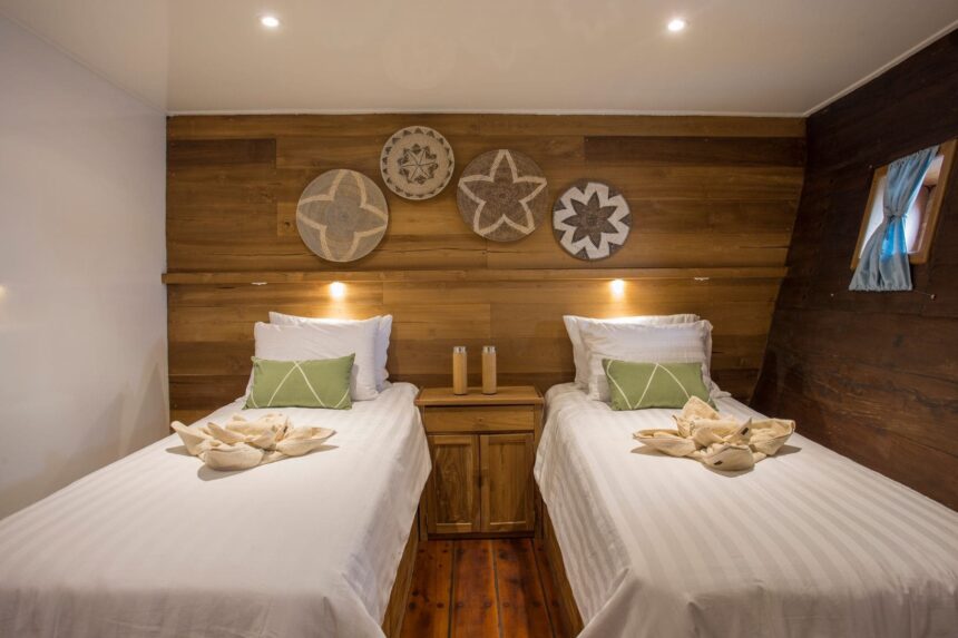 twin bed cabin with woven wall decor and folded towel art