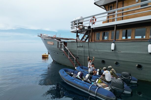 Emperor Harmoni liveaboard moored beside dive tenders loading divers