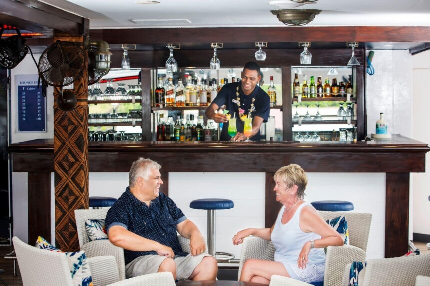 guests chatting with the bartender at the Fiji Princess's onboard bar
