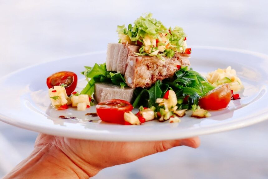 seared pork loin topped with tomato salsa on a Fiji Princess dinner plate