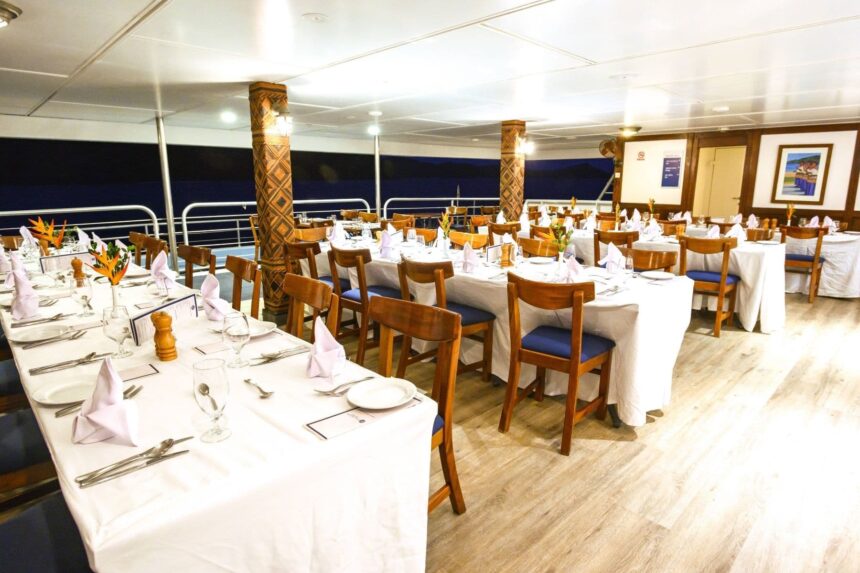 dining room set with white linens and folded napkins aboard the Fiji Princess