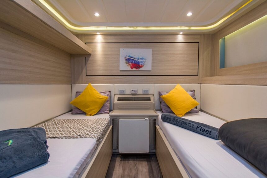 Twin cabin aboard the Grand Sea Explorer with yellow accent pillows